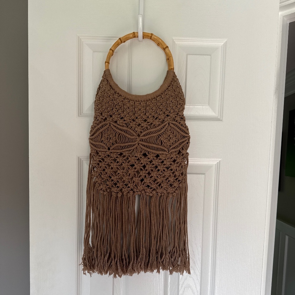 Tan macrame fringe handbag with bright leopard liner. Round wood handle